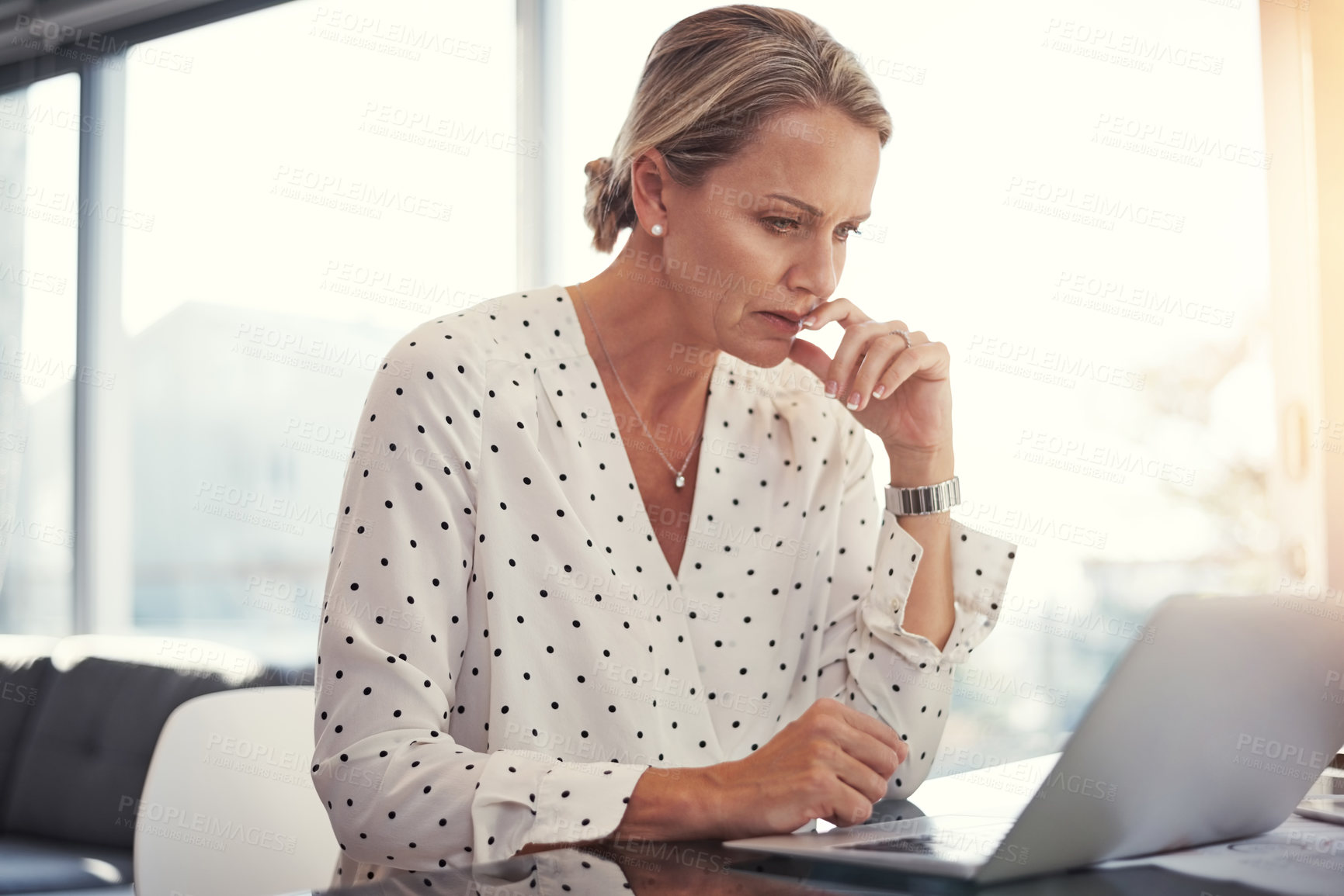 Buy stock photo Cropped shot of a mature businesswoman working from her home office