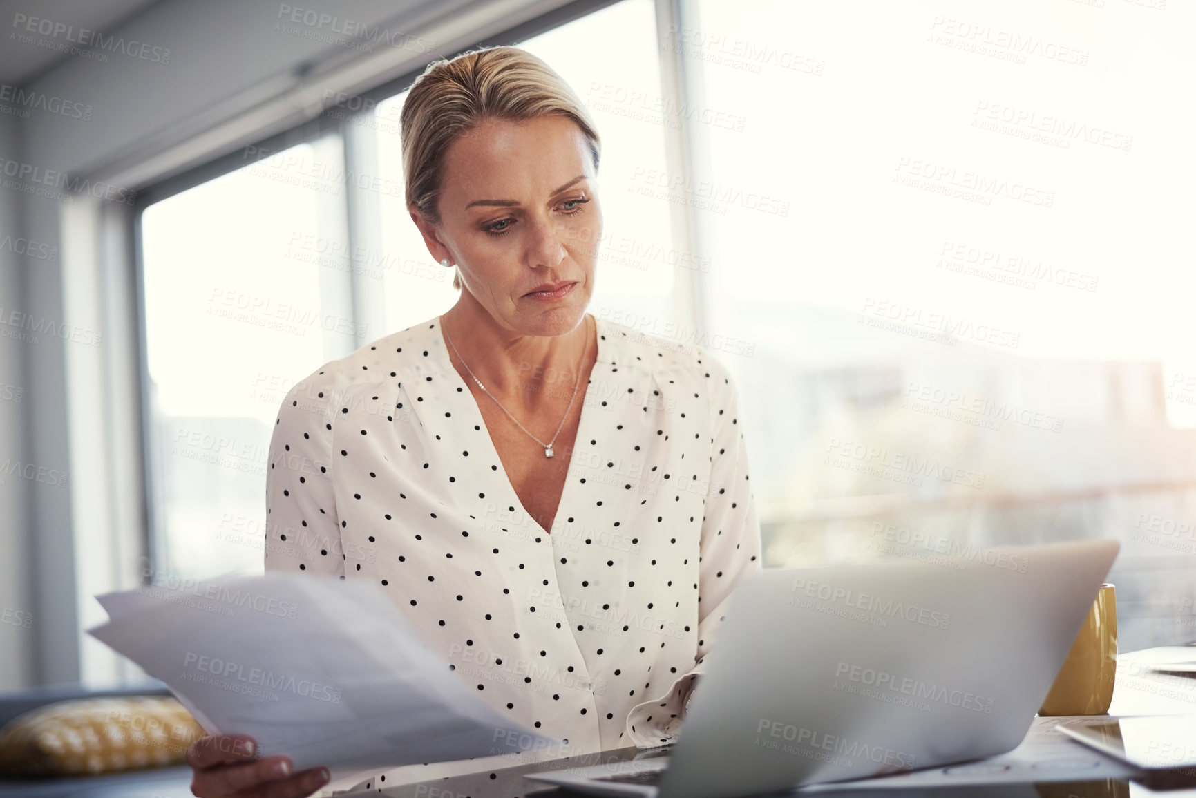 Buy stock photo Cropped shot of a mature businesswoman working from her home office