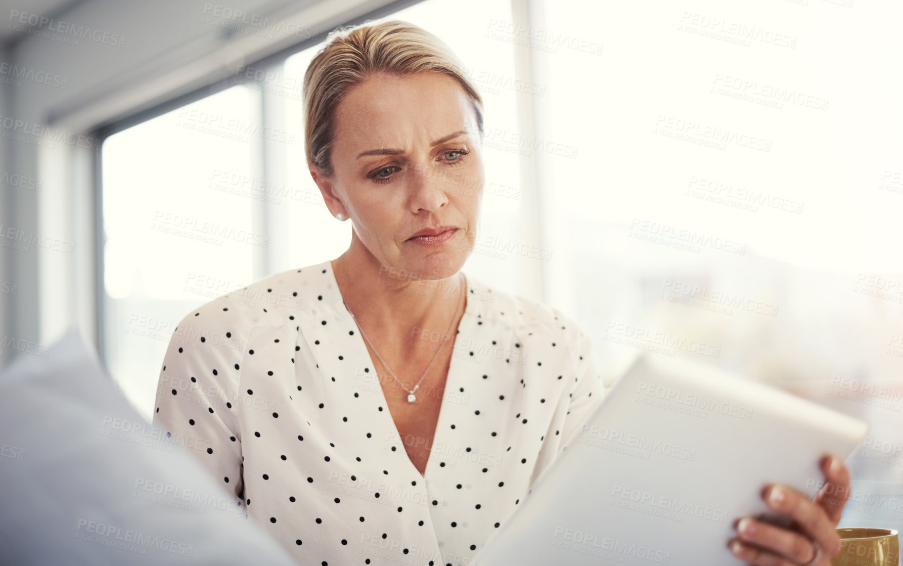 Buy stock photo Cropped shot of a mature businesswoman working from her home office