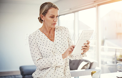 Buy stock photo Cropped shot of a mature businesswoman working from her home office