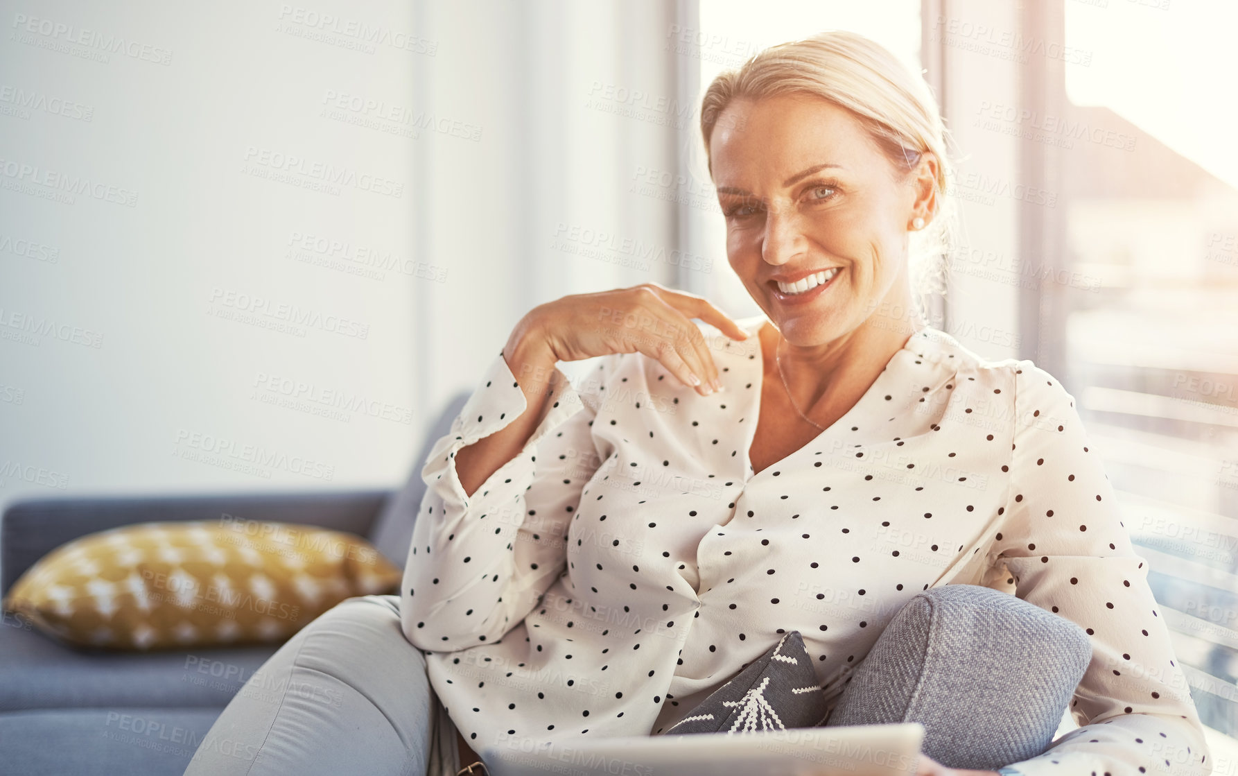 Buy stock photo Shot of a happy mature woman relaxing on the sofa at home