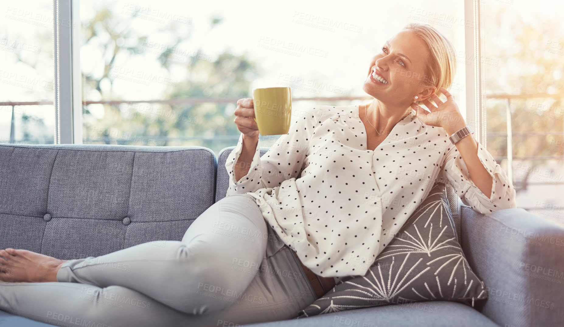 Buy stock photo Shot of a happy mature woman relaxing on the sofa at home