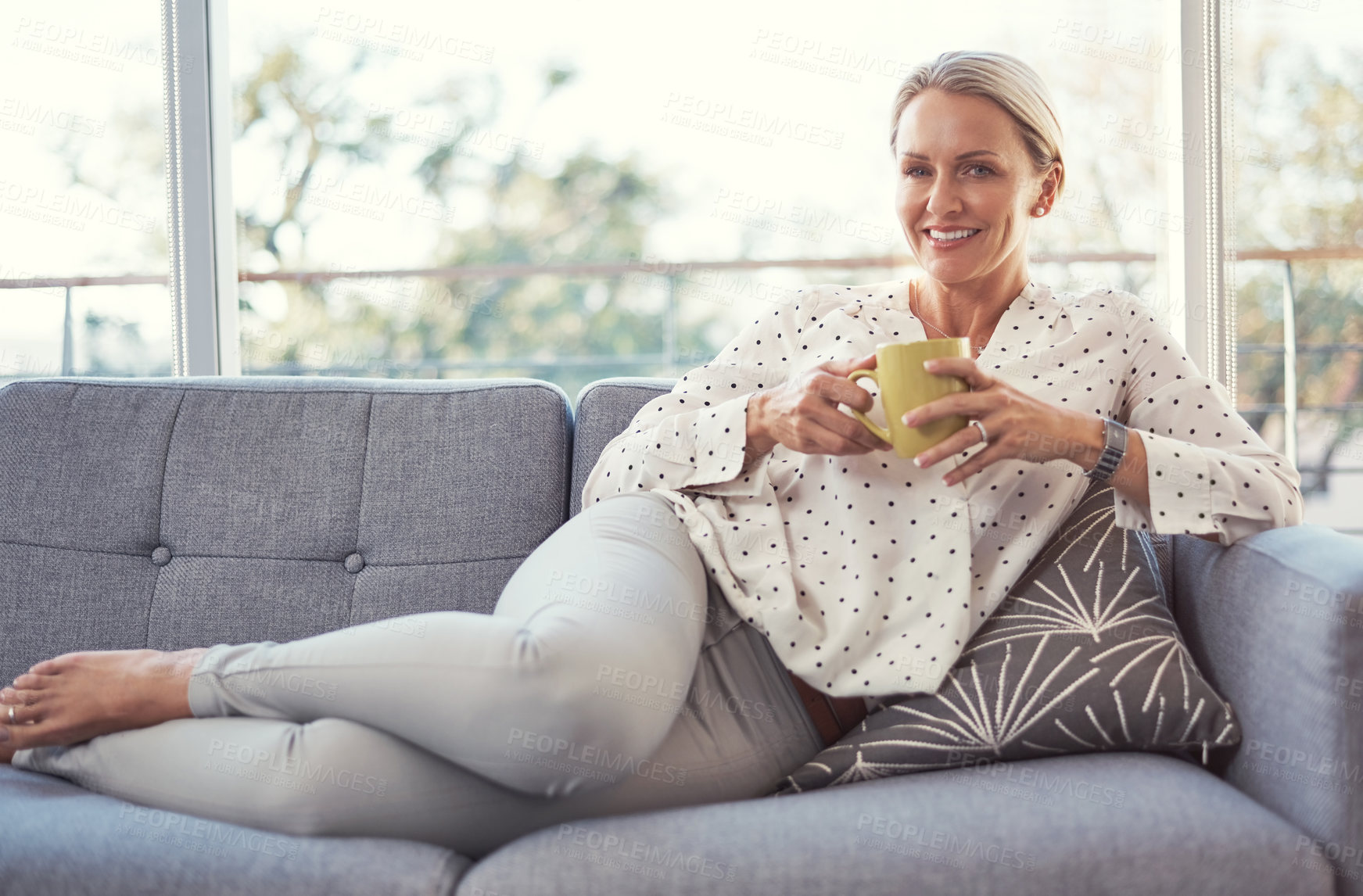 Buy stock photo Happy woman, portrait and break with coffee on sofa for morning beverage or start in home. Mature, female person or relax with smile or lying on living room couch for comfort or drink in house