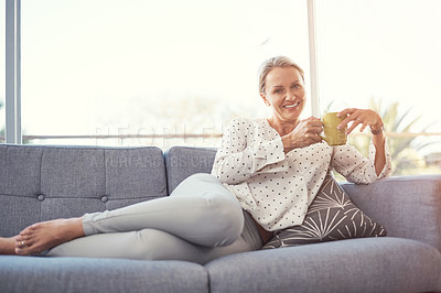 Buy stock photo Shot of a happy mature woman relaxing on the sofa at home