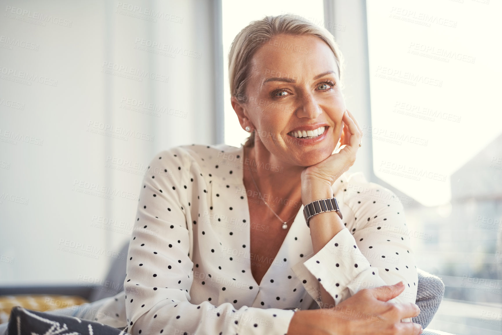 Buy stock photo Shot of a happy mature woman relaxing on the sofa at home