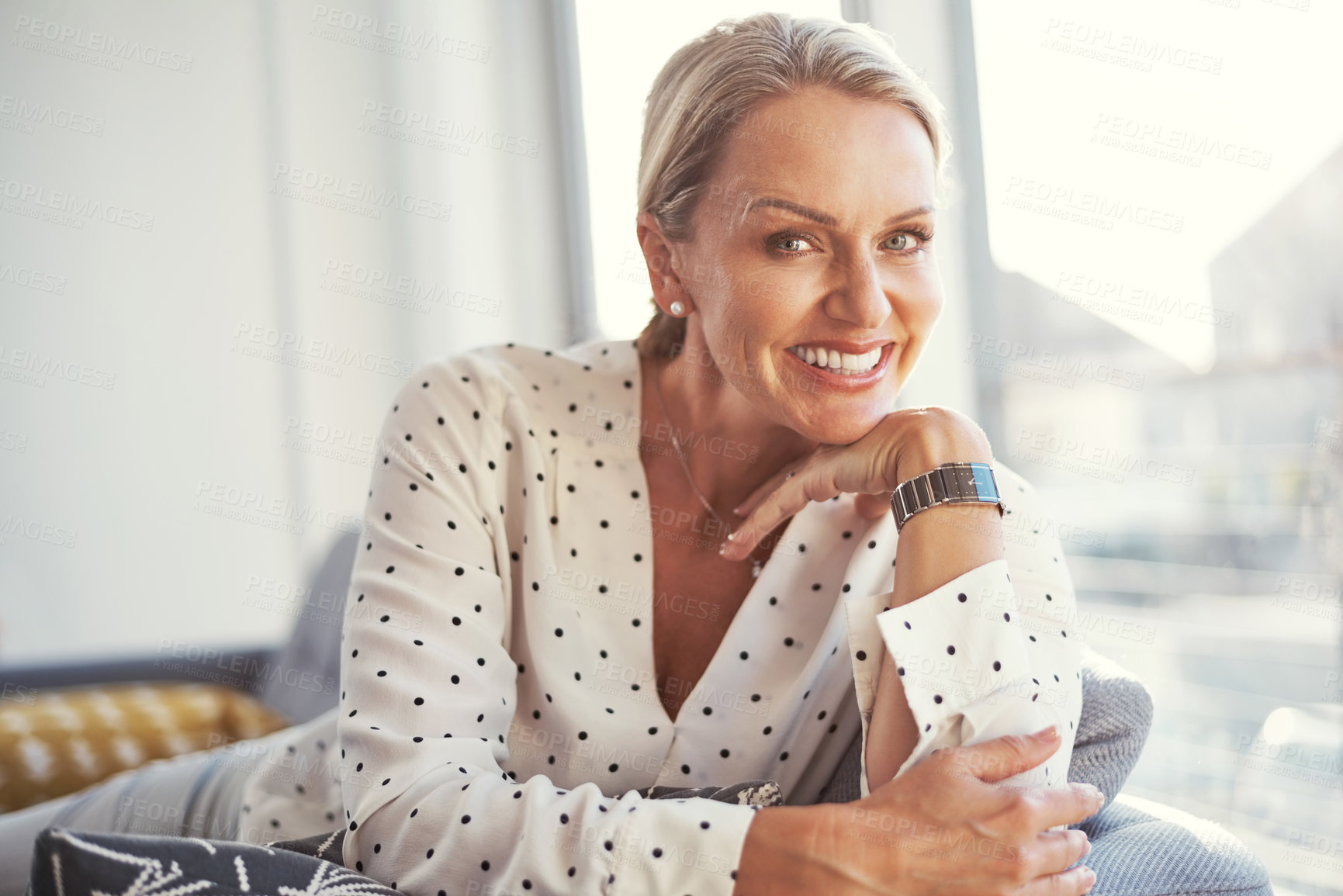 Buy stock photo Shot of a happy mature woman relaxing on the sofa at home