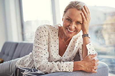 Buy stock photo Shot of a happy mature woman relaxing on the sofa at home