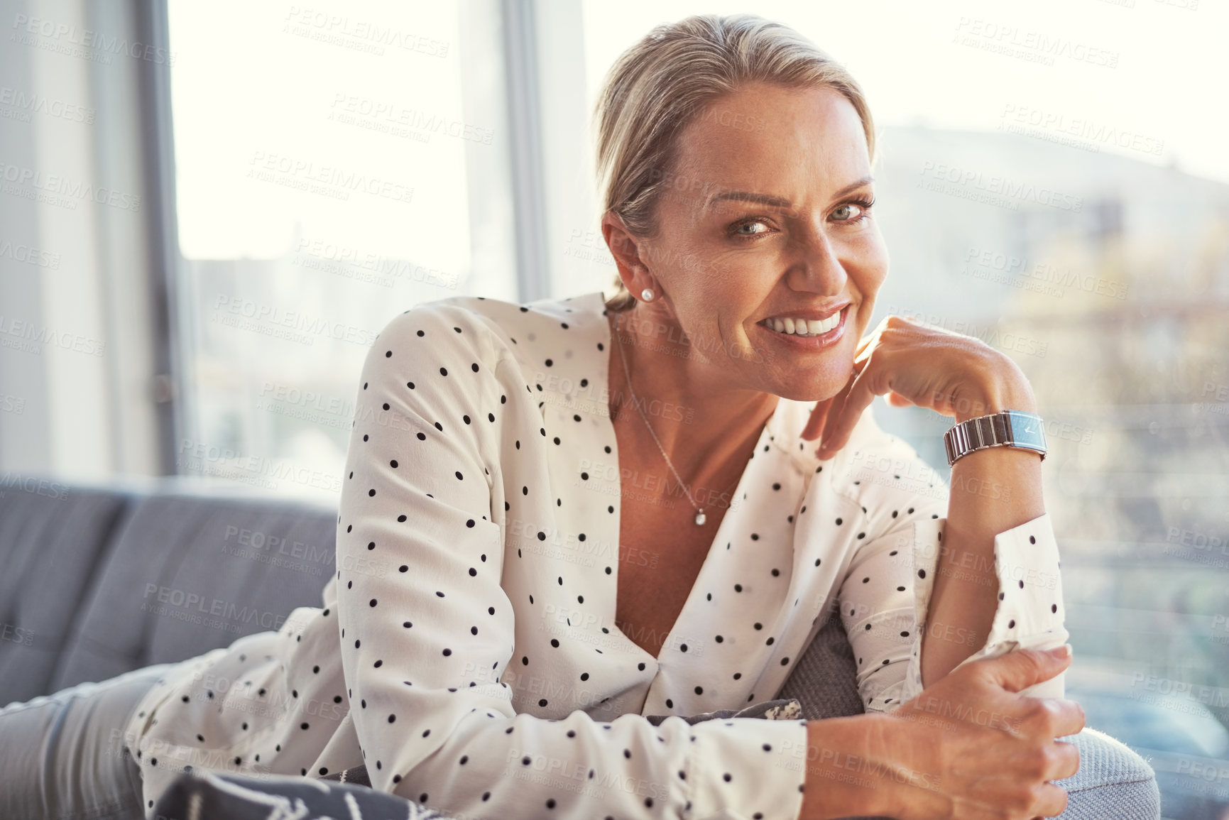 Buy stock photo Shot of a happy mature woman relaxing on the sofa at home