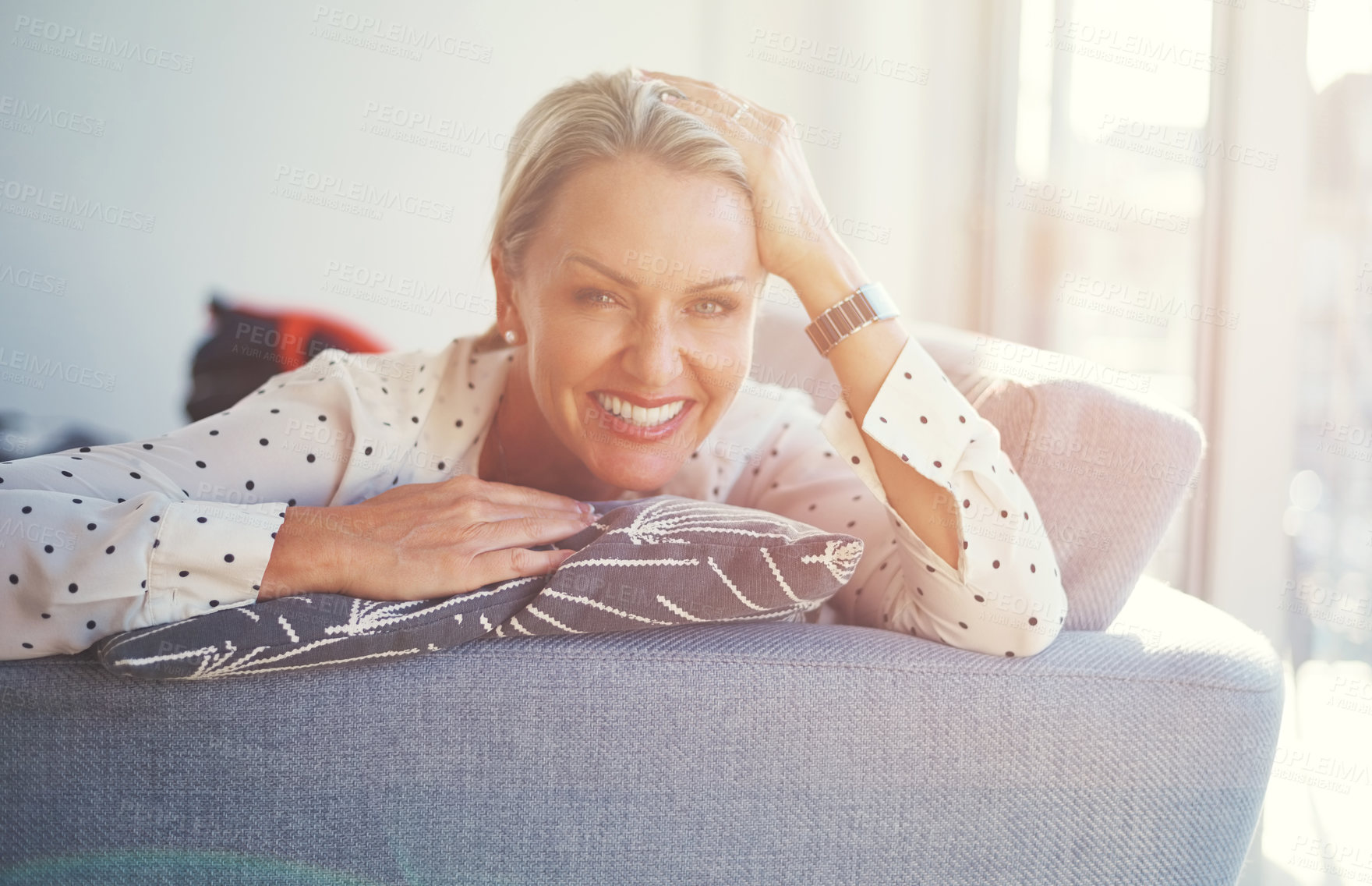 Buy stock photo Shot of a happy mature woman relaxing on the sofa at home