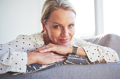 Buy stock photo Shot of a happy mature woman relaxing on the sofa at home