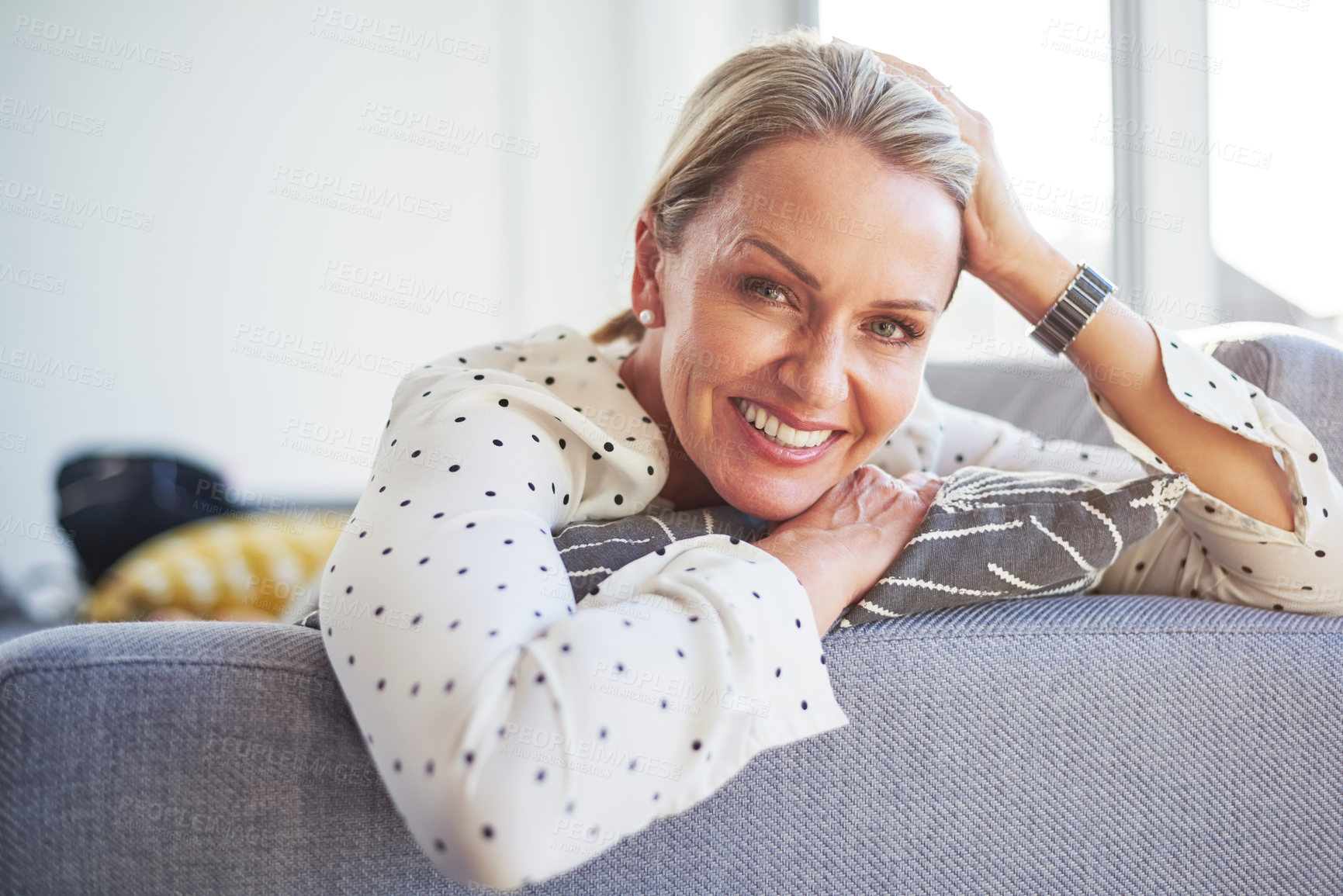 Buy stock photo Shot of a happy mature woman relaxing on the sofa at home