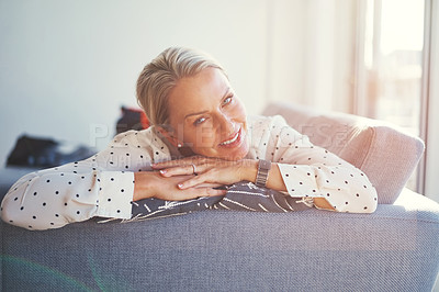 Buy stock photo Shot of a happy mature woman relaxing on the sofa at home