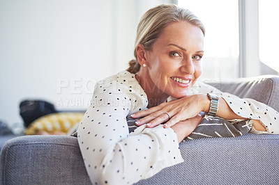 Buy stock photo Shot of a happy mature woman relaxing on the sofa at home