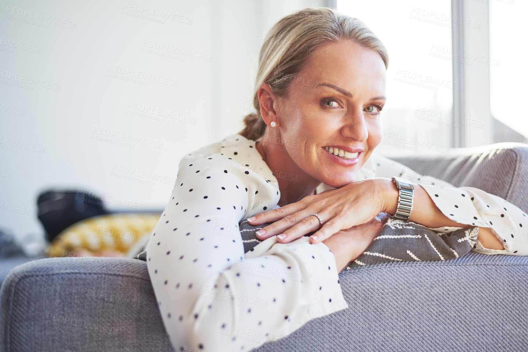 Buy stock photo Shot of a happy mature woman relaxing on the sofa at home