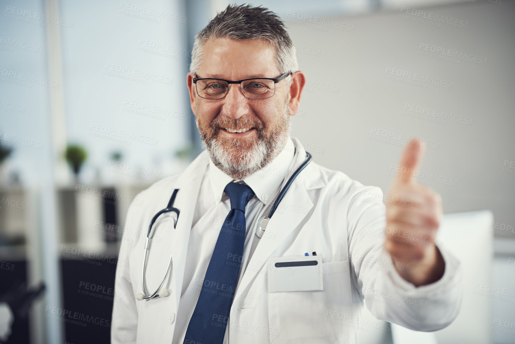 Buy stock photo Portrait of a confident and mature showing thumbs up in his office