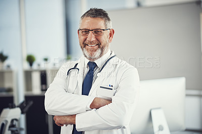 Buy stock photo Portrait of a confident and mature doctor standing in his office
