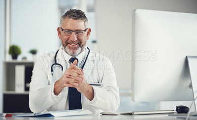 Buy stock photo Portrait of a mature doctor working at a desk in his office