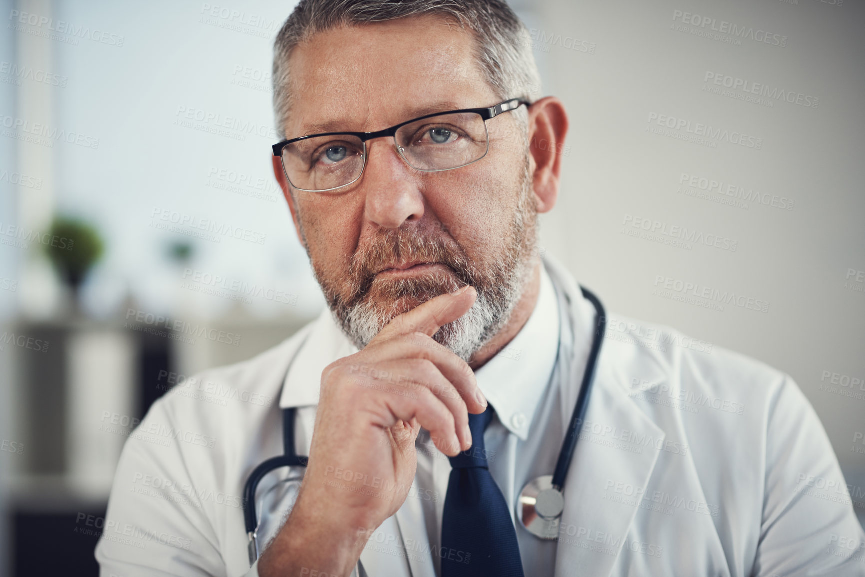 Buy stock photo Portrait of a confident and mature doctor standing in his office