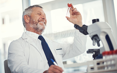 Buy stock photo Shot of a mature man conducting medical research in a laboratory
