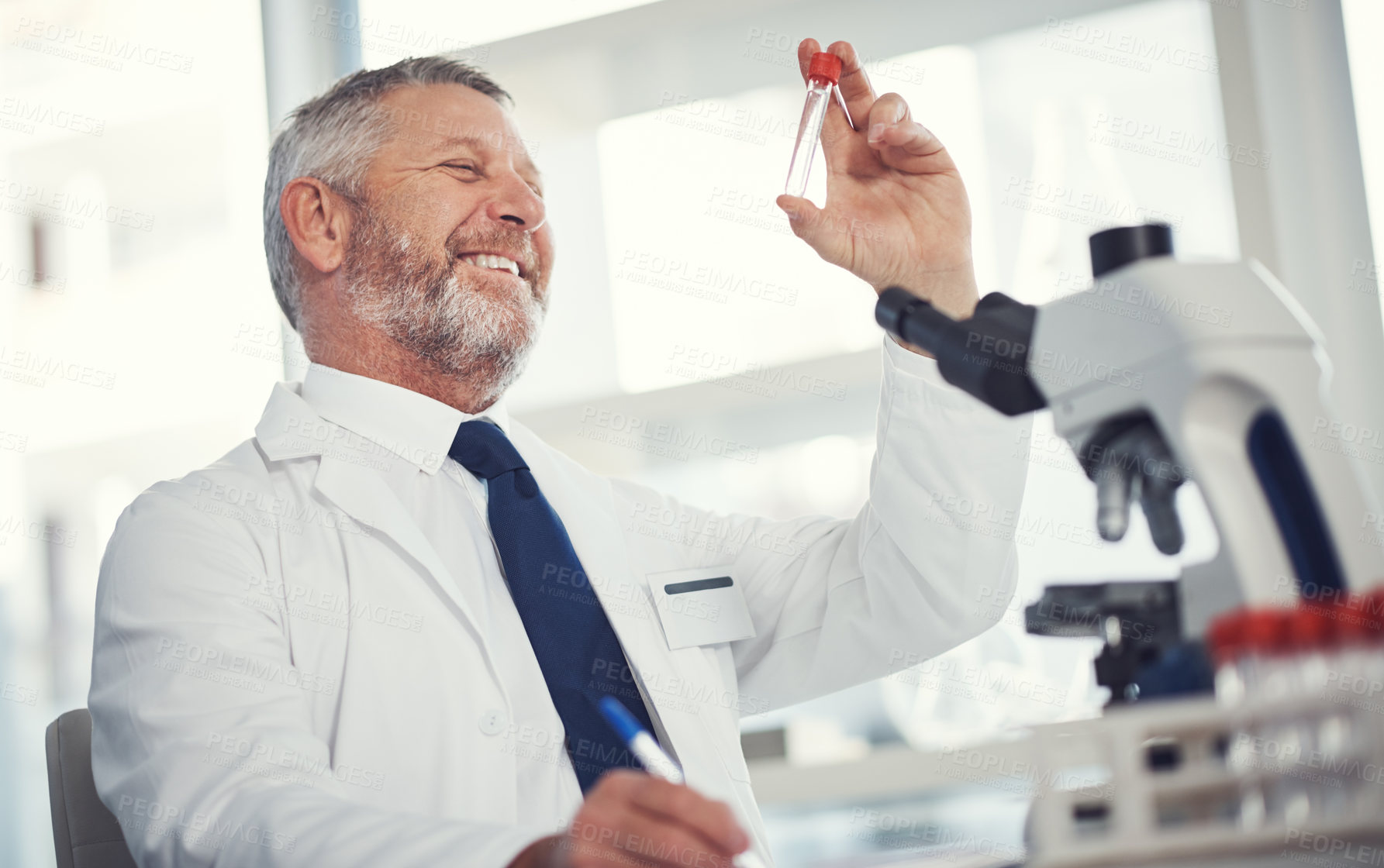 Buy stock photo Shot of a mature man conducting medical research in a laboratory