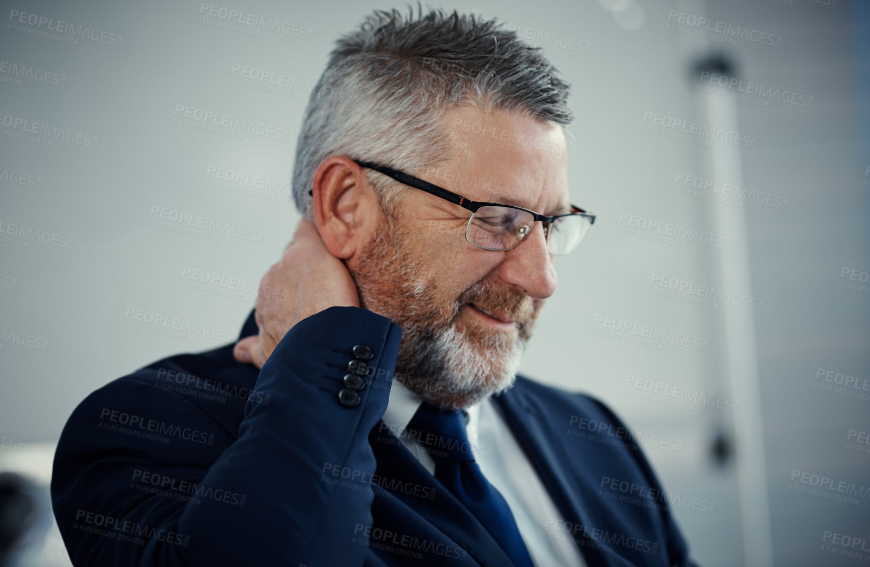 Buy stock photo Shot of a mature businessman experiencing neck ache at work in a modern office