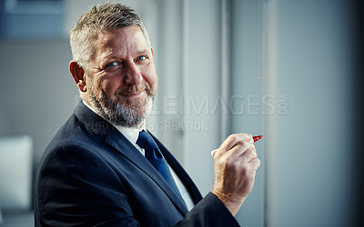 Buy stock photo Portrait of a mature businessman having a brainstorming session against a glass screen in a modern office