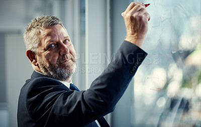 Buy stock photo Portrait of a mature businessman having a brainstorming session against a glass screen in a modern office