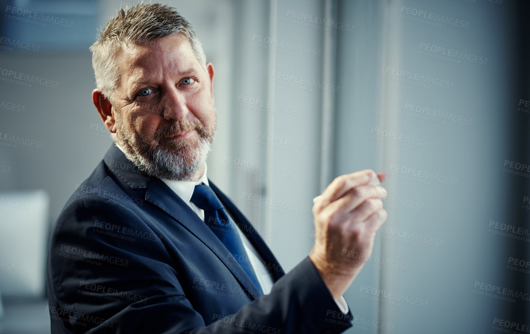 Buy stock photo Portrait of a mature businessman having a brainstorming session against a glass screen in a modern office