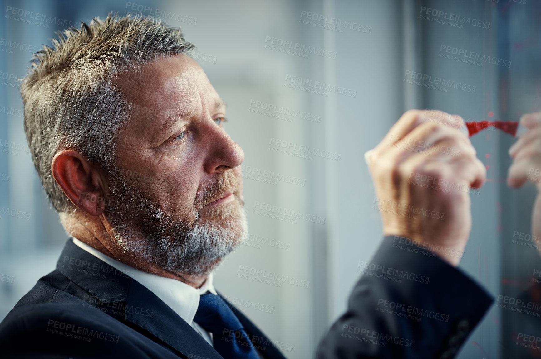 Buy stock photo Shot of a mature businessman having a brainstorming session against a glass screen in a modern office