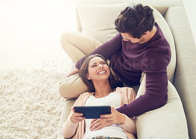 Buy stock photo Tablet, happy and couple relaxing on sofa in living room for entertainment together on couch at home. Smile, love and people networking on digital technology with internet in lounge at apartment.
