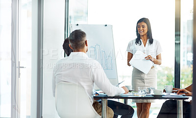 Buy stock photo Shot of a businesswoman giving a presentation to her colleagues in a modern office