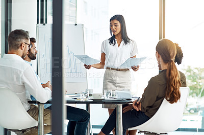 Buy stock photo Shot of a businesswoman giving a presentation to her colleagues in a modern office
