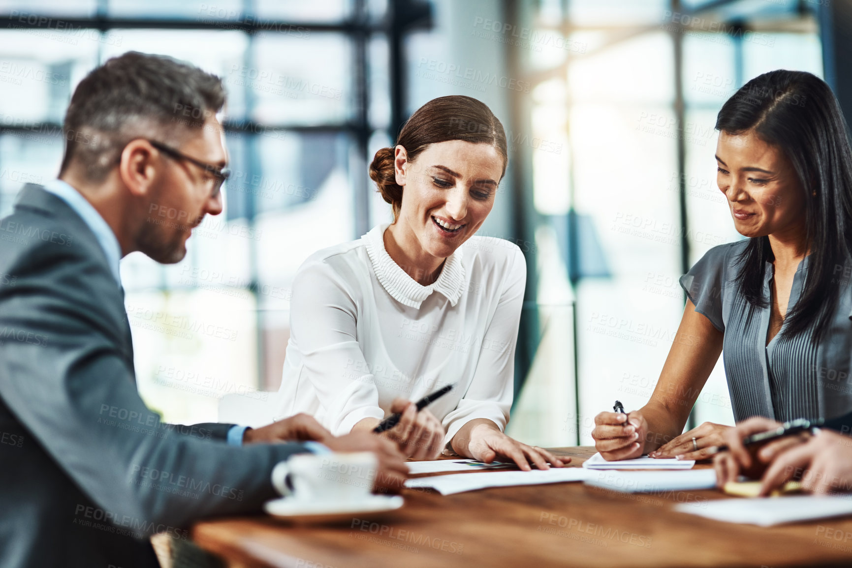 Buy stock photo Shot of a group of colleagues having a meeting in a modern office