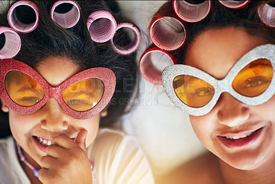 Buy stock photo High angle shot of a mother and her little girl wearing curlers while lying down