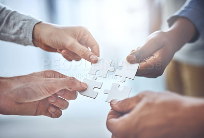 Buy stock photo Closeup shot of a group of unrecognisable businesspeople holding puzzle pieces together