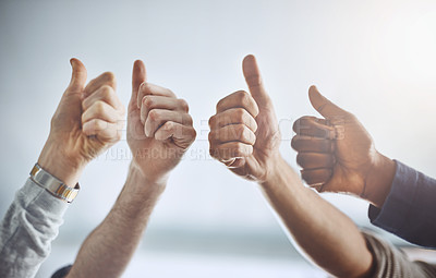 Buy stock photo Closeup shot of a group of unrecognisable businesspeople showing thumbs up in an office