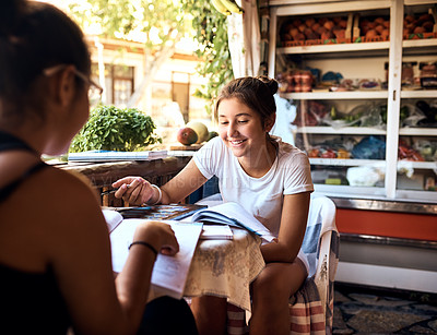 Buy stock photo Cropped shot of a mother and daughter sitting in a cafe while on vacation