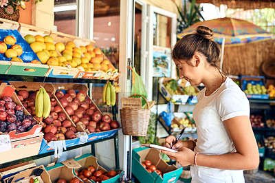 Buy stock photo Cropped shot of an attractive young woman working at a farm stall