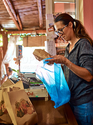 Buy stock photo Cropped shot of a mature woman working at a farm stall