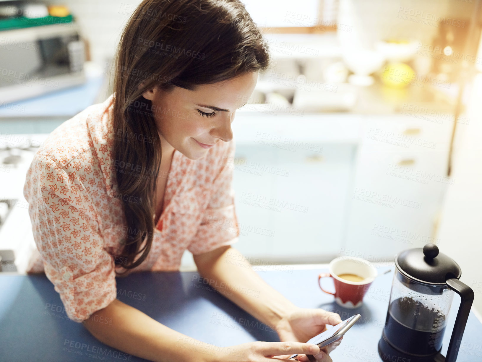 Buy stock photo Phone, connection and woman in kitchen at house networking on social media, internet or mobile app. Happy, cellphone and female person reading online email or text in morning for connectivity at home