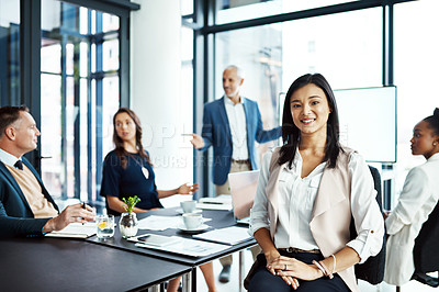 Buy stock photo Businesswoman sitting in a modern boardroom presentation with diverse colleagues. Businesspeople brainstorming in a conference room. Happy, smiling and professional female working with her team.