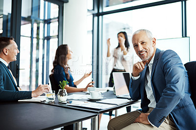 Buy stock photo Portrait of a businessman sitting in a boardroom presentation with colleagues