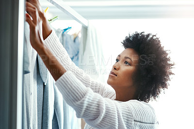 Buy stock photo Black woman, home and hygiene with hanging laundry for housekeeping, duties and domestic. Female person, washing and drying clothes with happiness for cleaning and chores on day off and enjoy.