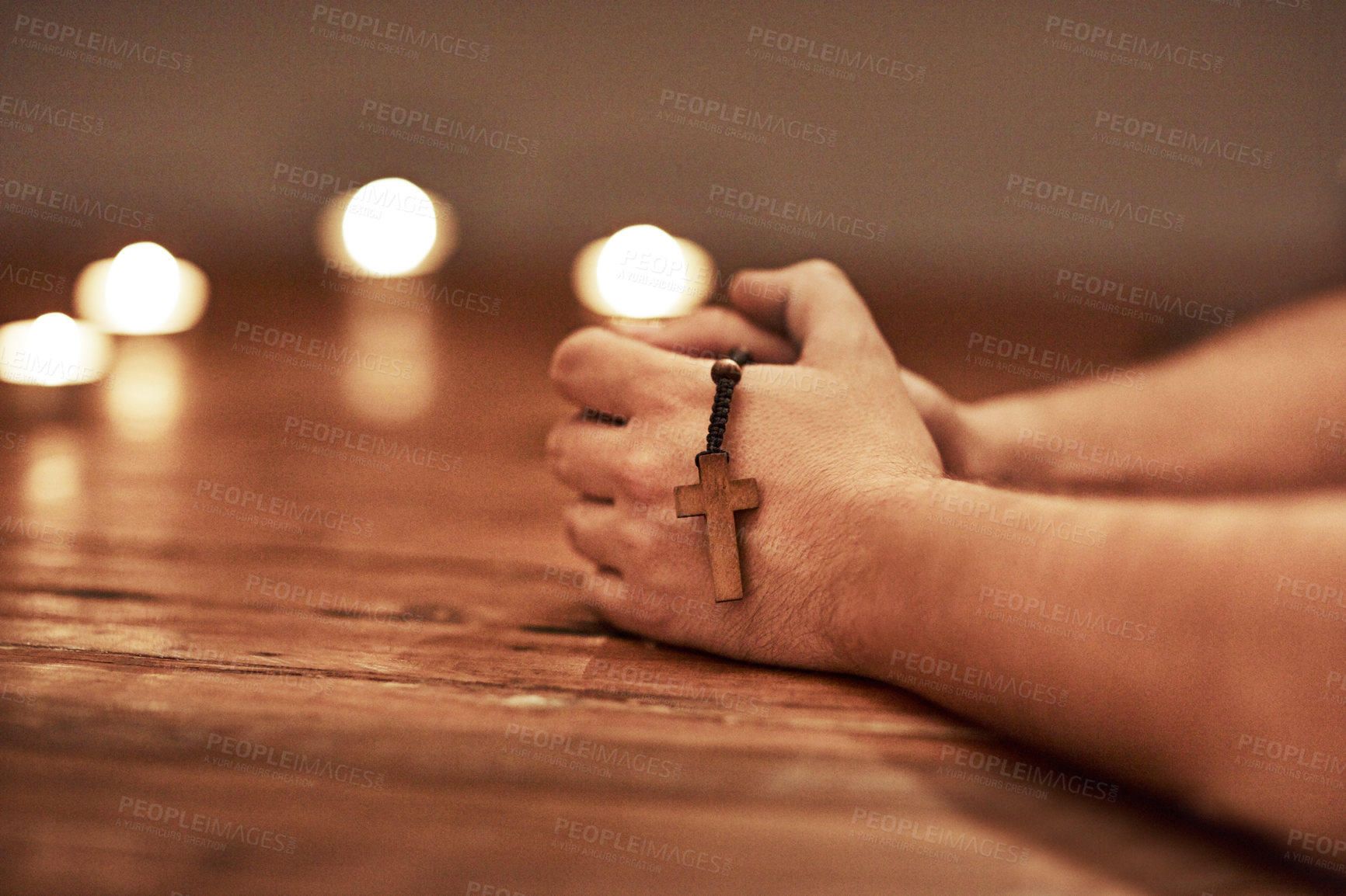 Buy stock photo Cropped shot of a man holding a rosary and praying