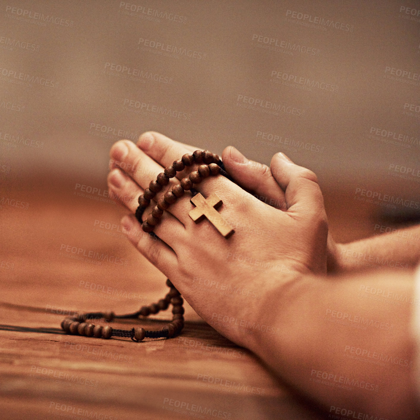 Buy stock photo Cropped shot of a man holding a rosary and praying