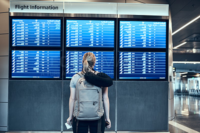 Buy stock photo Back, woman and airport on flight schedule board with airline times and information. Female person, tourist and travel with backpack for adventure, vacation and holiday with passport for departure