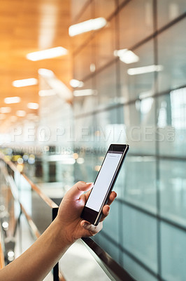 Buy stock photo Cropped shot of an unrecognizable woman sending a text while standing in an airport