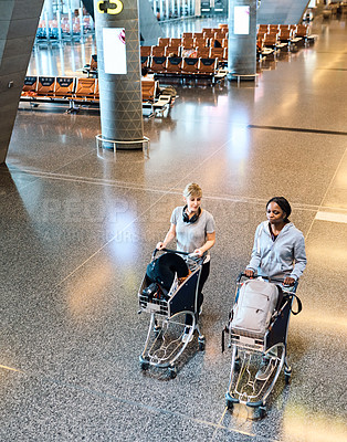 Buy stock photo Travel, friends and women at airport with trolley for vacation, holiday or trip together. Walking, luggage and girls at airline with passport for journey or conversation at flight boarding gate above