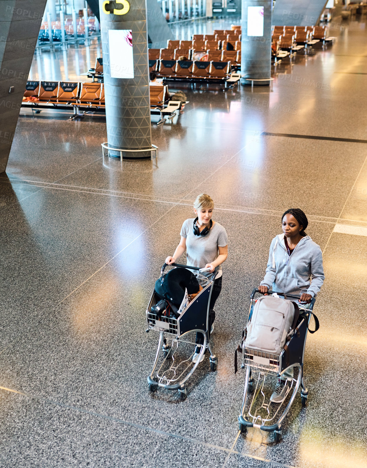 Buy stock photo Travel, friends and women at airport with trolley for vacation, holiday or trip together. Walking, luggage and girls at airline with passport for journey or conversation at flight boarding gate above