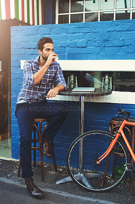 Buy stock photo Outdoor, creative and businessman at cafe with coffee, laptop and bicycle for urban professional with remote work. Relax, drink and freelance man at sidewalk restaurant on break from online project